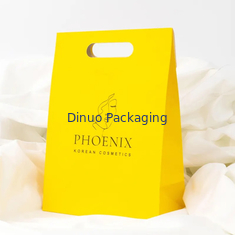Embalaje de ropa Manija de corte a presión Bolsas de papel Kraft personalizadas Bolsas de regalo amarillas