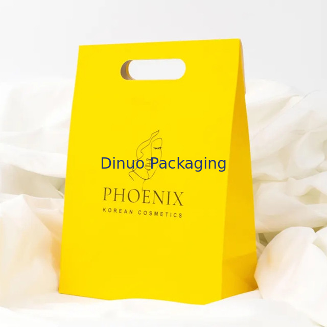 Embalaje de ropa Manija de corte a presión Bolsas de papel Kraft personalizadas Bolsas de regalo amarillas