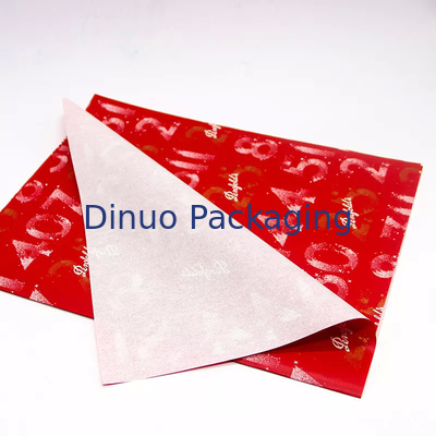 Envoltura de regalo de Navidad que empaqueta el papel de seda rojo con la impresión floral de la hoja de oro